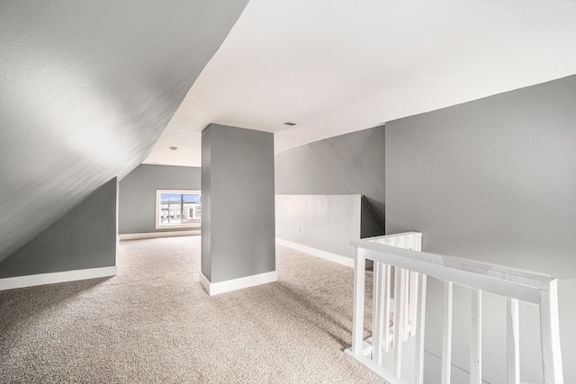 bonus room featuring baseboards, lofted ceiling, and carpet
