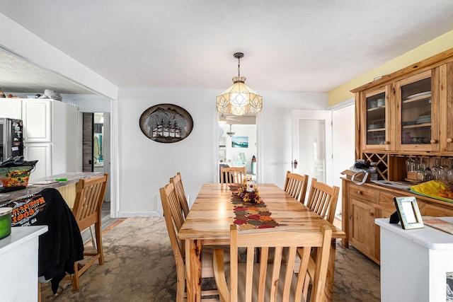 dining room featuring light carpet