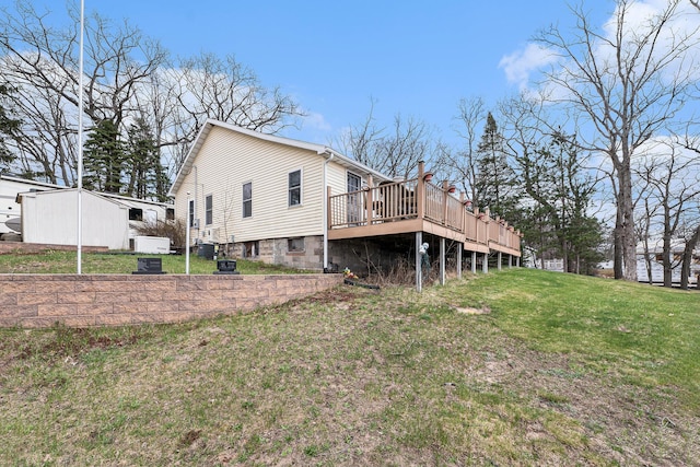 rear view of property with a yard and a deck