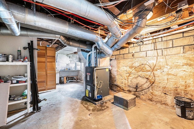 unfinished basement featuring heating unit and a sink
