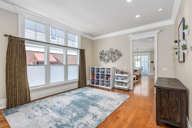 sitting room featuring plenty of natural light, recessed lighting, ornamental molding, and light wood-type flooring