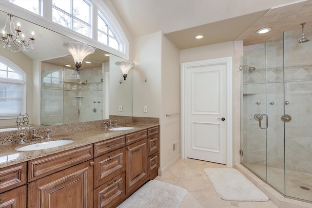 full bathroom with a sink, tile patterned floors, a stall shower, and double vanity