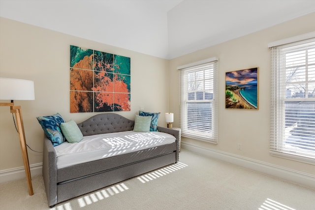 sitting room with carpet floors, baseboards, and lofted ceiling