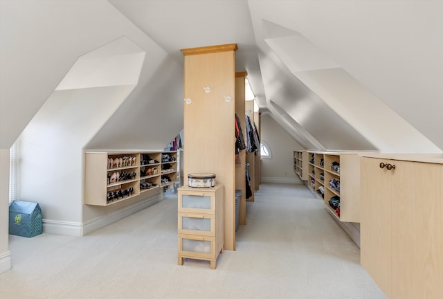 additional living space with light colored carpet, baseboards, and vaulted ceiling