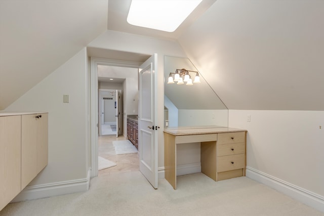 interior space featuring light colored carpet, baseboards, and vaulted ceiling