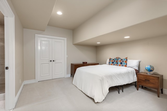 bedroom with light colored carpet, recessed lighting, and baseboards