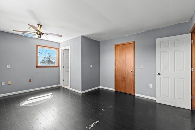 spare room with baseboards and a ceiling fan