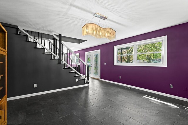 foyer entrance with an inviting chandelier, stairs, and a wealth of natural light