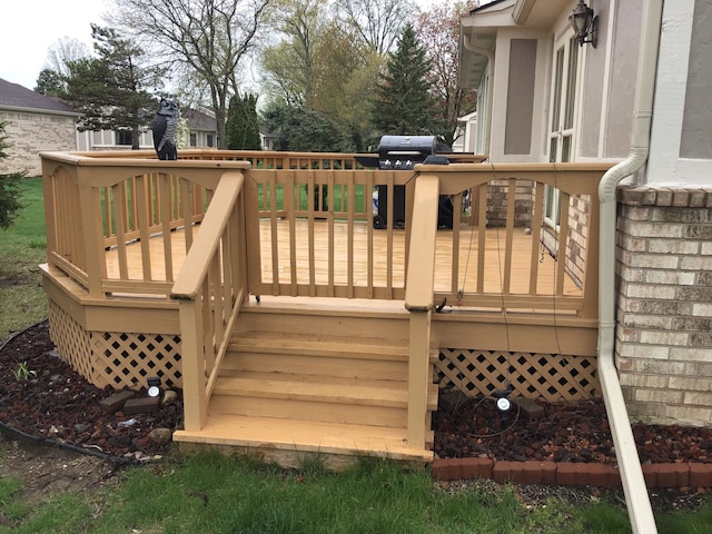 deck featuring stairs and a grill