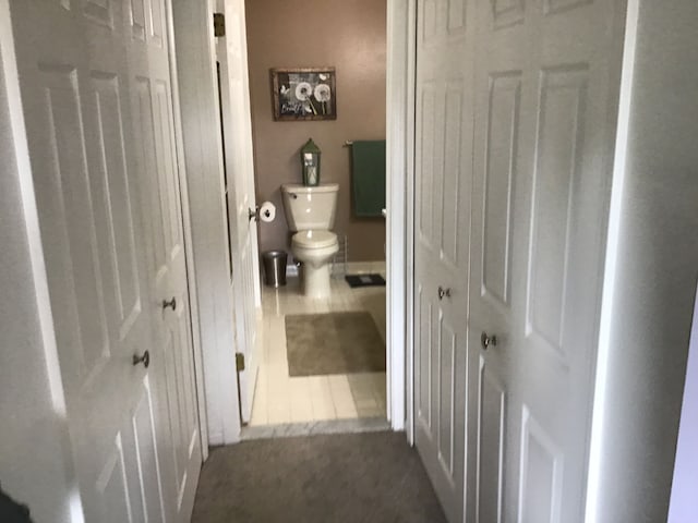 bathroom with tile patterned flooring and toilet