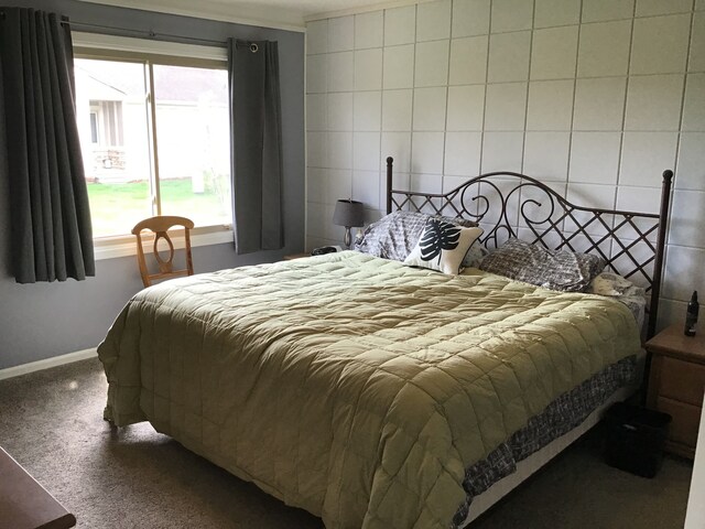 carpeted bedroom featuring baseboards