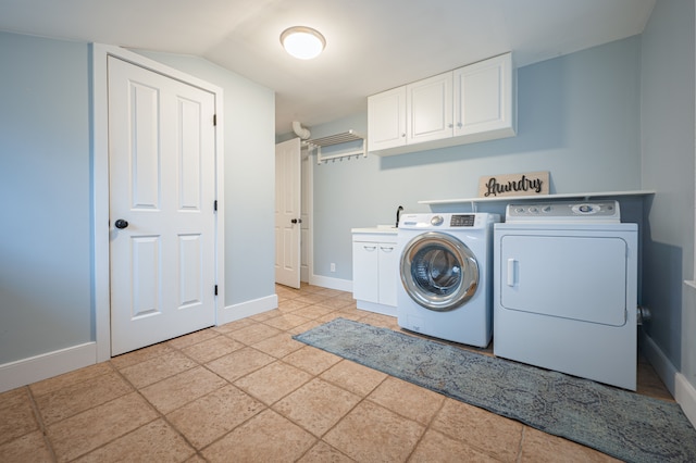 laundry room featuring cabinet space, baseboards, washing machine and dryer, and a sink