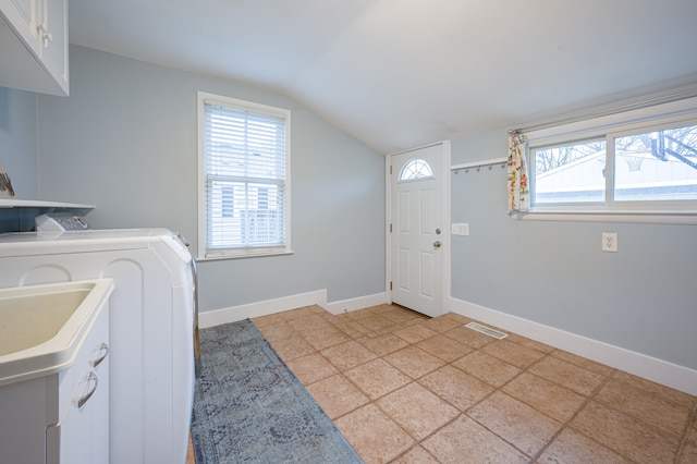 laundry room featuring cabinet space, light tile patterned flooring, separate washer and dryer, baseboards, and visible vents