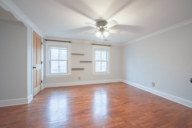 unfurnished room with baseboards, ceiling fan, ornamental molding, and wood finished floors