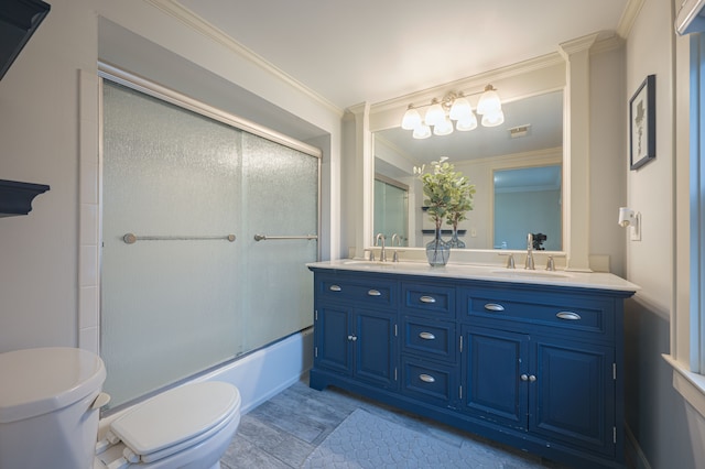 full bath with double vanity, toilet, a sink, and shower / bath combination with glass door