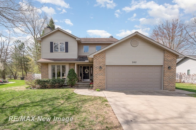 traditional-style house with brick siding, a garage, a front yard, a chimney, and driveway