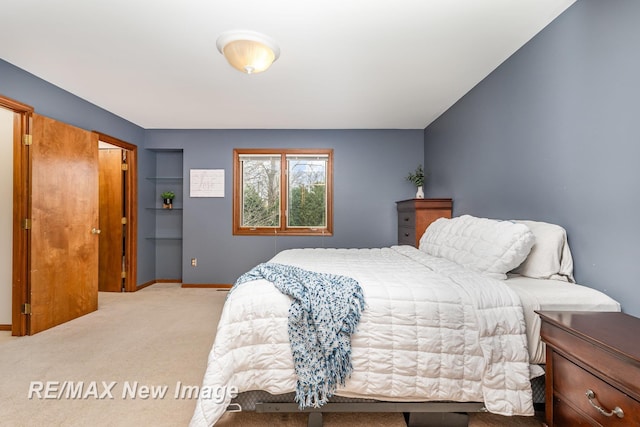 bedroom featuring baseboards and carpet
