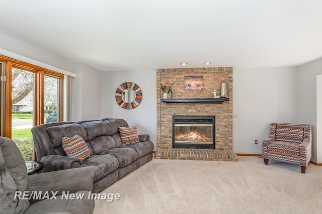 carpeted living room with a brick fireplace and baseboards