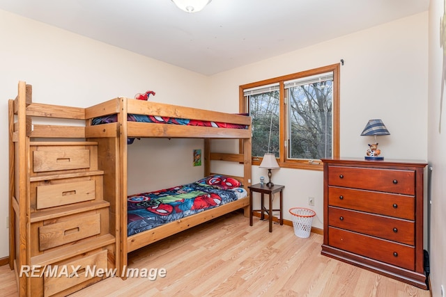 bedroom with baseboards and wood finished floors