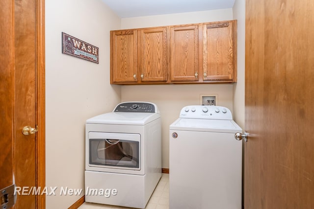 washroom with cabinet space and washer and dryer