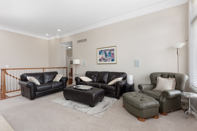 living area featuring visible vents, ornamental molding, and recessed lighting