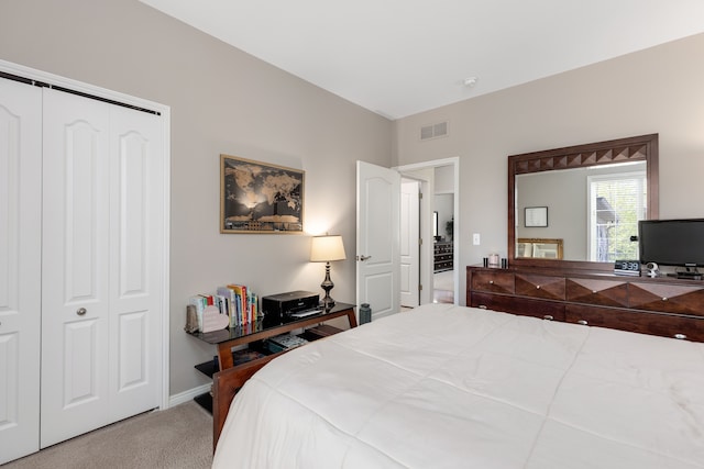 bedroom with carpet floors, baseboards, visible vents, and a closet