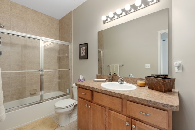 full bathroom with tile patterned flooring, enclosed tub / shower combo, toilet, and vanity