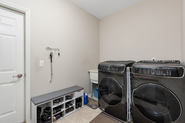 clothes washing area with tile patterned flooring, laundry area, and washer and dryer