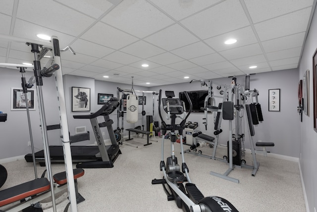 workout area featuring recessed lighting, baseboards, and a drop ceiling