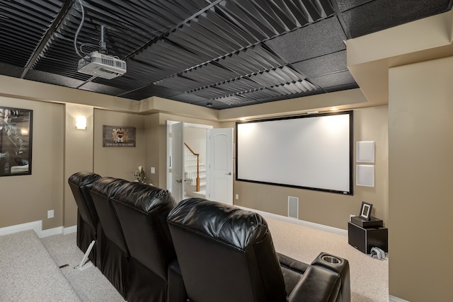 carpeted home theater with baseboards