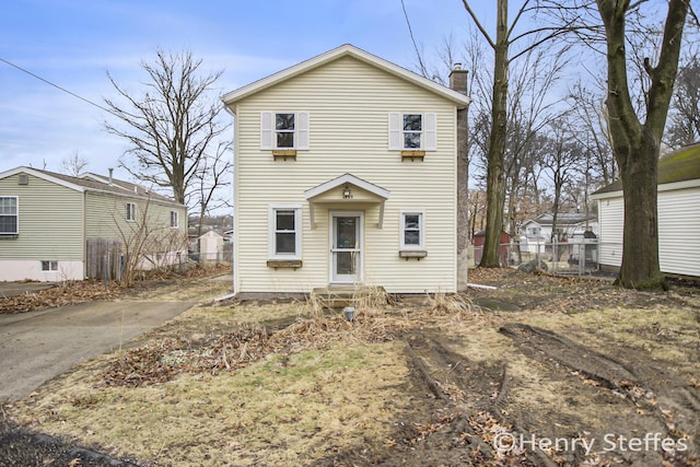 1355 Middle Ln, Battle Creek, MI 49014 - view of front of house featuring a chimney and entry steps