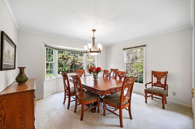 dining room featuring crown molding, baseboards, a chandelier, and light carpet