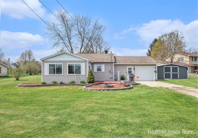ranch-style house featuring a front lawn, a garage, a shed, an outdoor structure, and driveway