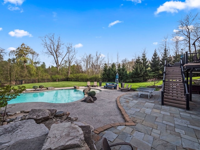 outdoor pool featuring a patio area, a yard, and stairway