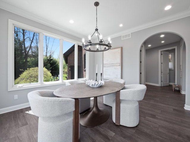 dining room with visible vents, arched walkways, baseboards, a notable chandelier, and ornamental molding