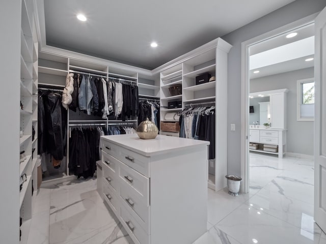 spacious closet featuring marble finish floor