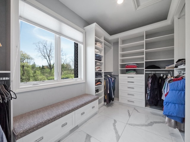 walk in closet featuring marble finish floor