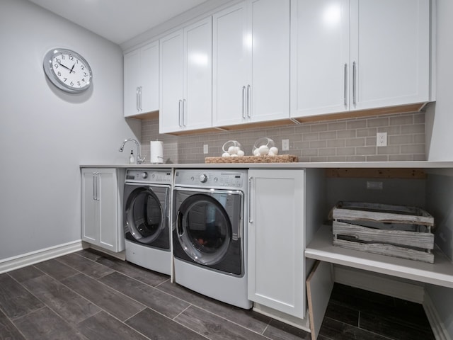 washroom with independent washer and dryer, wood finish floors, baseboards, and cabinet space