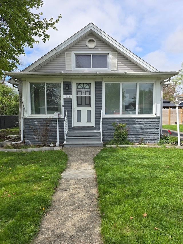 1068 La Salle Ave, Waterford, MI 48328 - view of front of home featuring entry steps, a front lawn, and stone siding