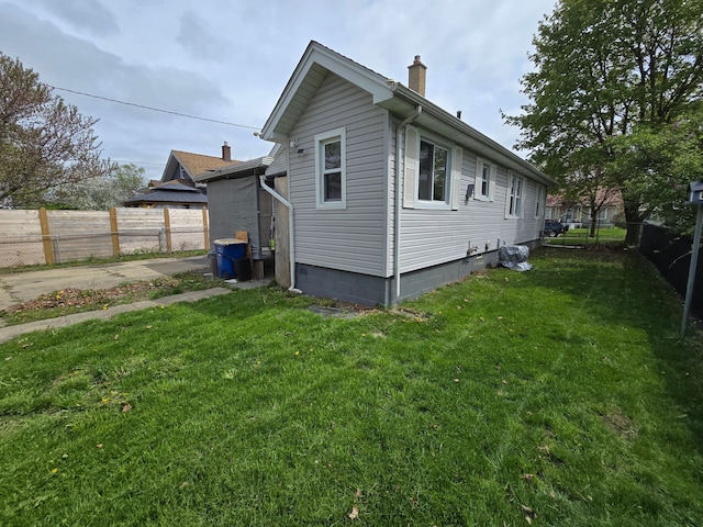 1068 La Salle Ave, Waterford, MI 48328 - view of side of property featuring fence, a chimney, and a lawn