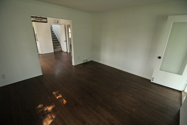 1068 La Salle Ave, Waterford, MI 48328 - spare room featuring crown molding, visible vents, dark wood-style flooring, baseboards, and stairs