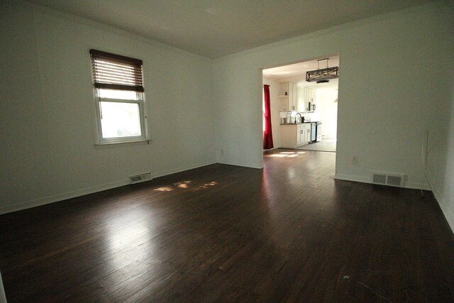 1068 La Salle Ave, Waterford, MI 48328 - unfurnished room featuring crown molding, visible vents, and dark wood-style floors
