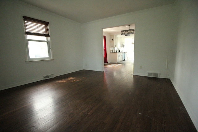 1068 La Salle Ave, Waterford, MI 48328 - spare room with crown molding, visible vents, dark wood-style flooring, and baseboards