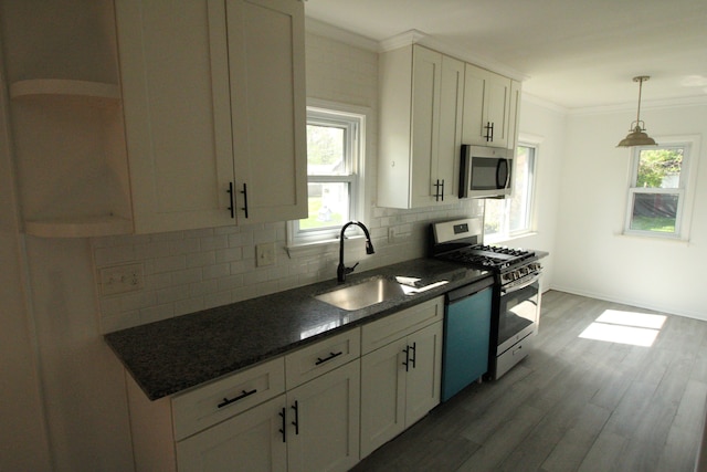 1068 La Salle Ave, Waterford, MI 48328 - kitchen featuring a sink, white cabinetry, decorative backsplash, wood finished floors, and stainless steel appliances