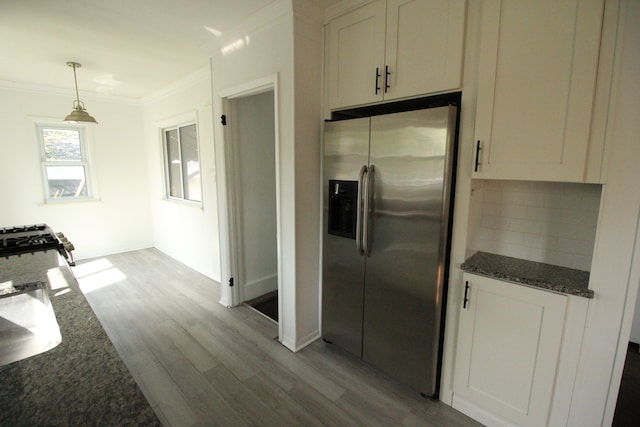 1068 La Salle Ave, Waterford, MI 48328 - kitchen featuring wood finished floors, dark stone countertops, stainless steel refrigerator with ice dispenser, crown molding, and backsplash