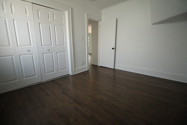 1068 La Salle Ave, Waterford, MI 48328 - unfurnished bedroom with baseboards, a closet, and dark wood-style floors