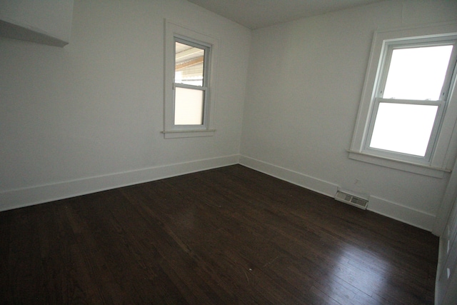 1068 La Salle Ave, Waterford, MI 48328 - spare room featuring a healthy amount of sunlight, baseboards, visible vents, and dark wood finished floors