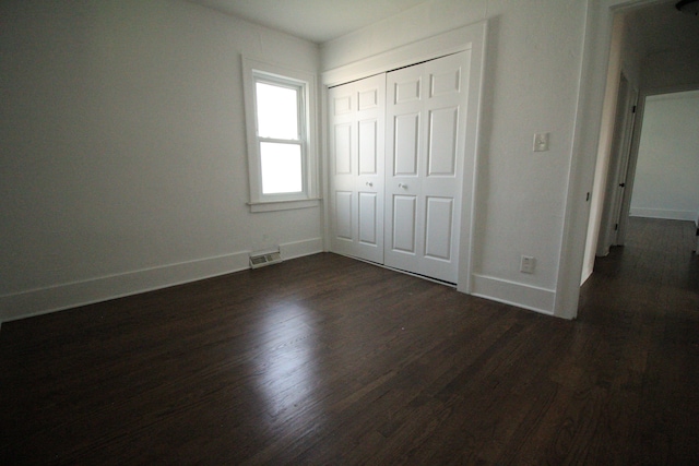 1068 La Salle Ave, Waterford, MI 48328 - unfurnished bedroom with visible vents, baseboards, and dark wood-style floors