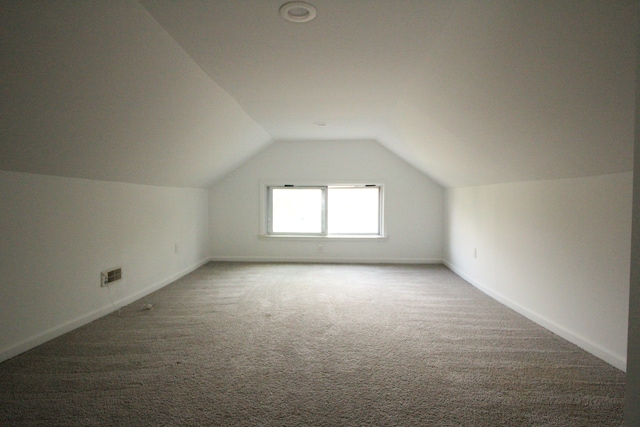 1068 La Salle Ave, Waterford, MI 48328 - additional living space with lofted ceiling, baseboards, visible vents, and carpet
