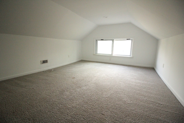 1068 La Salle Ave, Waterford, MI 48328 - additional living space with baseboards, light carpet, and vaulted ceiling